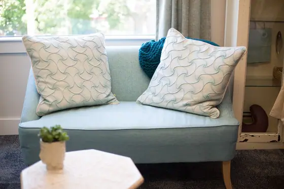 Teal sofa with patterned cushions
